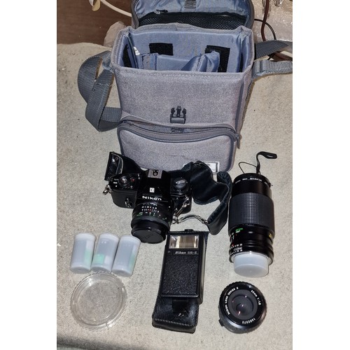 254 - Nikon EM 35 mm SLR camera in carry case with 2 x extra lenses, flash gun etc