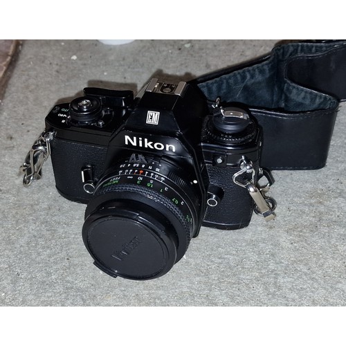 254 - Nikon EM 35 mm SLR camera in carry case with 2 x extra lenses, flash gun etc