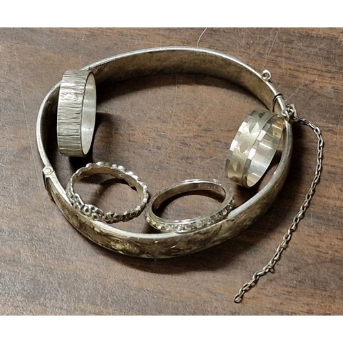 155 - Bundle of mis-shaped silver bangle and 4 x similar silver rings