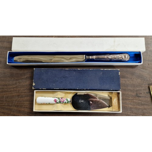 131 - Boxed silver plated wedding cake knife and boxed floral handle cake slice