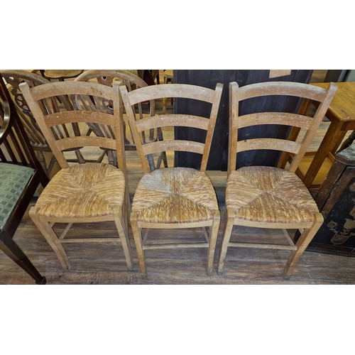 338 - Set of three, old straw seat ladderback rustic chairs