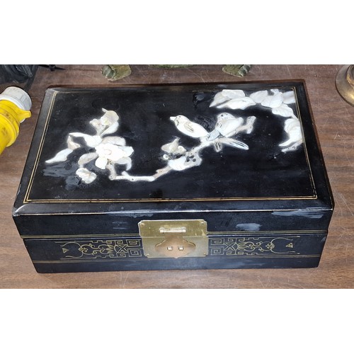 119 - 28 x 18.5 x 10 cm black lacquer jewellery box with raised mother of pearl top (some damage)