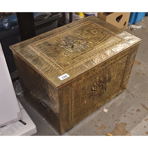 228 - 59 x 39 x 39 cm brass covered fireside coal/log box with raised scene pattern