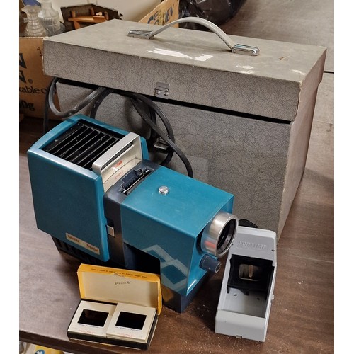 38 - Vintage Kodak 50 projector in case with small box of 1960's slides & current PAT test - all proceeds... 