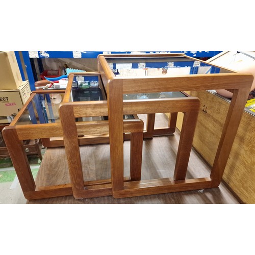 151 - Retro un-named teak nest of three tables with smoked glass tops