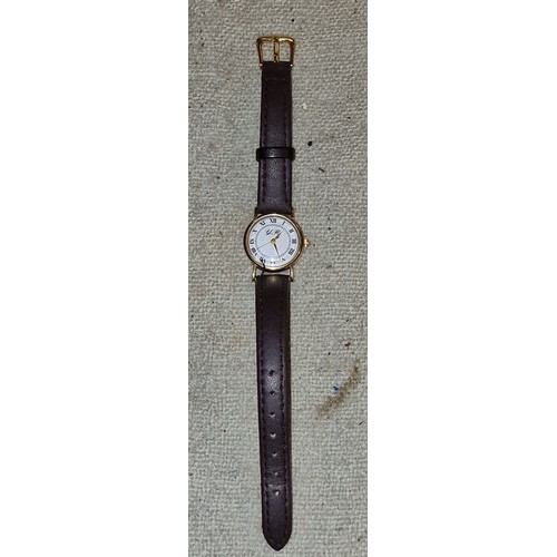 84A - YR ladies 9 ct gold cased watch in working order with leather strap