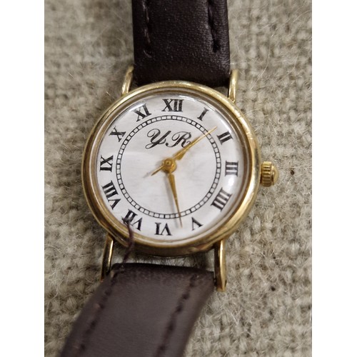 84A - YR ladies 9 ct gold cased watch in working order with leather strap