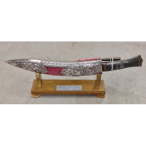 148 - Presentation Kukri/Ghurkha knife in very ornate sheath and on display stand with presentation plaque