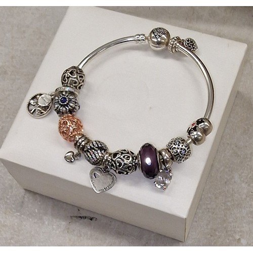 319 - Believed genuine Pandora bangle with 12 x charms - some charms genuine, few may or may not be