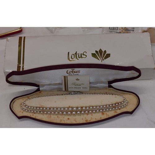 331 - Boxed and cased Lotus simulated pearl graduated two strand necklace