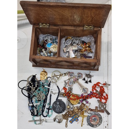 76 - Wooden chest shaped trinket box with assorted religious pendants, rosaries, crosses etc