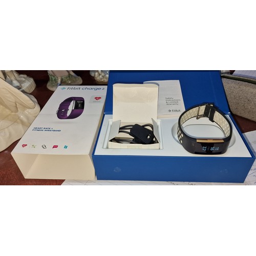 92 - Boxed and charged Fitbit Charge 2 with charger and instructions