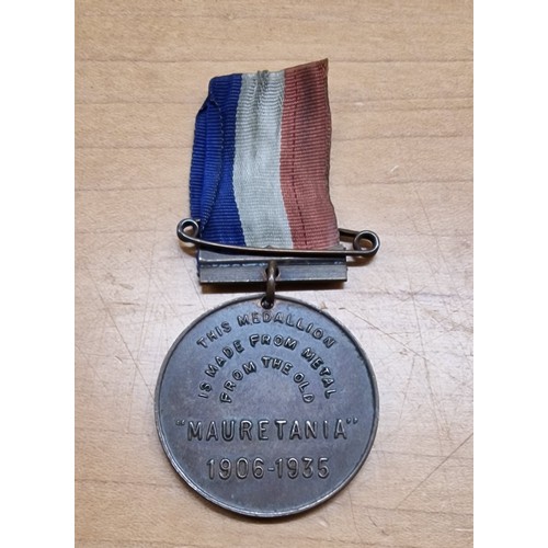 524 - RMS Mauretania medallion with ribbon made from metal from the ship