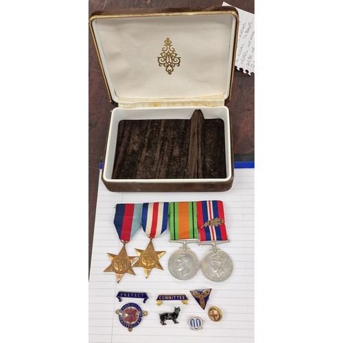 128 - Vintage jewellery box containing band of 4 x WWII medals (no inscriptions), 6 x enamel badges and 1 ... 