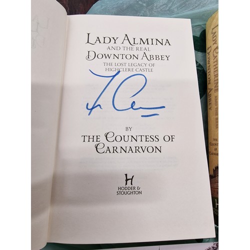 272 - 2 x Downton Abbey first edition books, both signed, 2 x postcards and leather book mark from Highcle... 