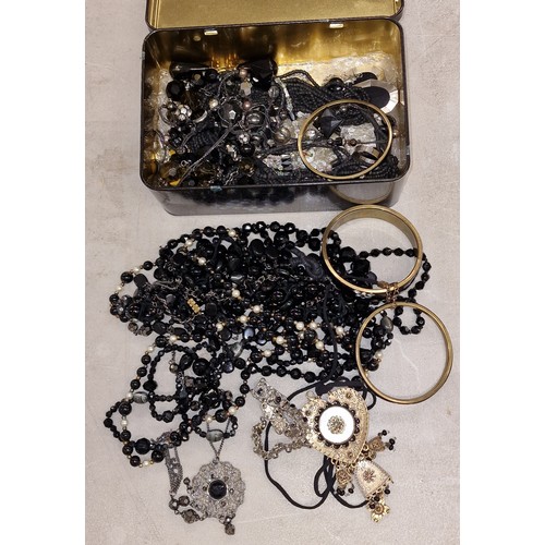 236 - Massilly France tin of assorted black jet style costume and dress jewellery