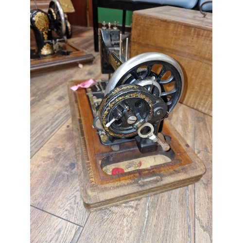 132 - Old Frister & Rossmann sewing machine with wooden case and key present