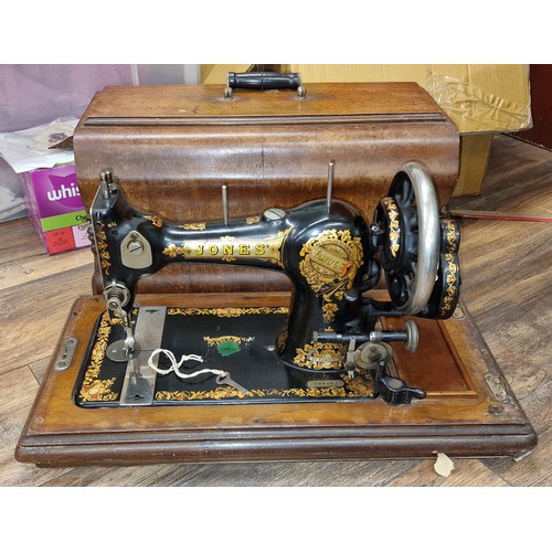 245 - Old Jones sewing machine with wooden case and key present