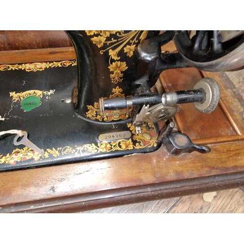 245 - Old Jones sewing machine with wooden case and key present