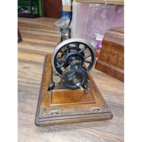 245 - Old Jones sewing machine with wooden case and key present