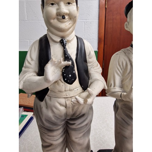 216 - Pair of vintage 44 cm tall composite Laurel & Hardy figures, both with fingers missing