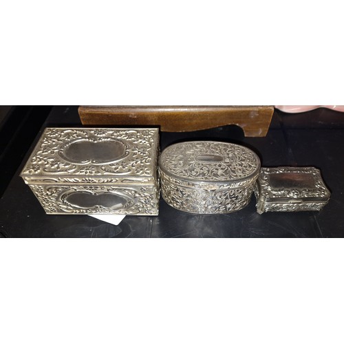 60 - Graduated trio of ornate silver plated trinket boxes, largest 10 x 6.5 x 4.5 cm