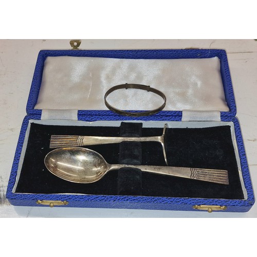 94 - Cased hallmarked silver spoon and food pusher set & sterling stamped christening bangle