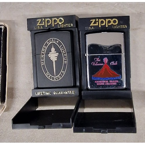 74 - 2 x cased as new Zippo lighters - Kuala Lumpar & Ascension Island