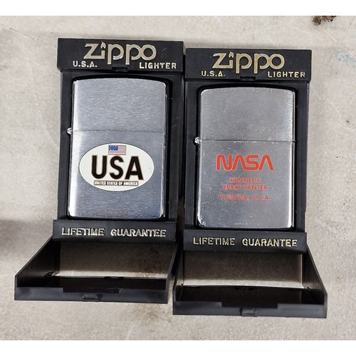 116 - 2 x cased as new Zippo lighters - USA & Kennedy Space Centre