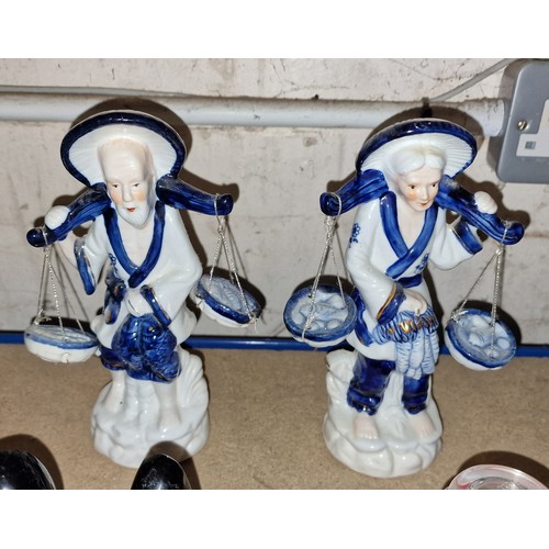 66 - 21 cm tall Chinese porcelain man and woman fish seller figures carrying baskets