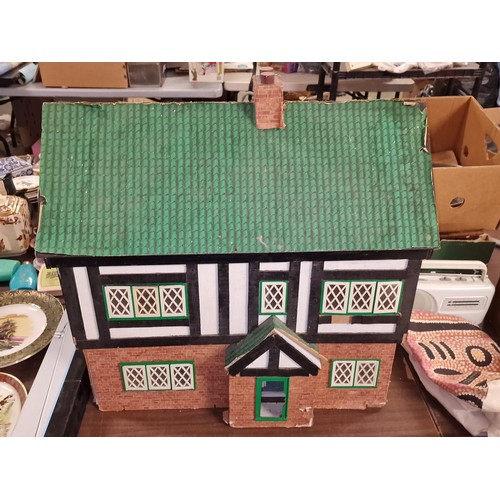 178 - Approximately 66.5 x 42.5 x 64.5 shed art dolls house, with minimal furniture and in need of TLC