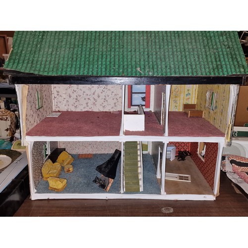 178 - Approximately 66.5 x 42.5 x 64.5 shed art dolls house, with minimal furniture and in need of TLC