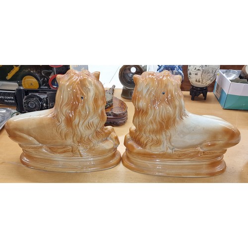 190 - Pair of 19th century Staffordshire Pottery fireside lions - 28 cm long and 24 cm tall