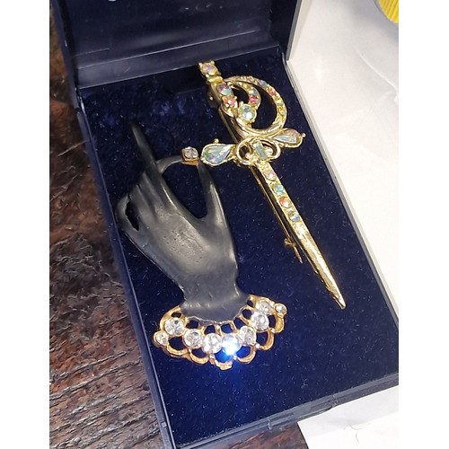 51 - 7.5 cm long jewelled sword brooch and other large jewelled black glove brooch