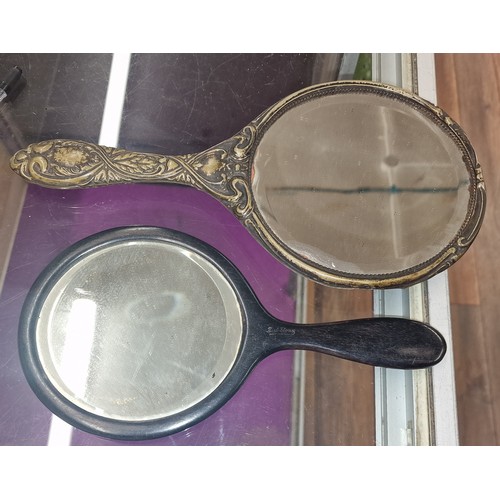 65 - Vintage Ebony hand held mirror and other ornate embossed white metal hand held mirror