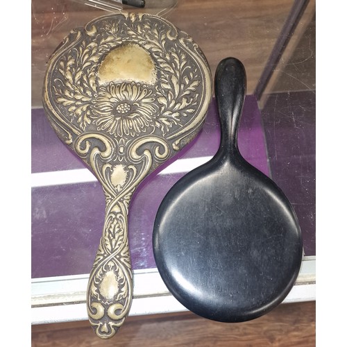 65 - Vintage Ebony hand held mirror and other ornate embossed white metal hand held mirror