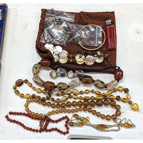 111 - Large jewellery bag with assorted brown/amber dress and costume jewellery