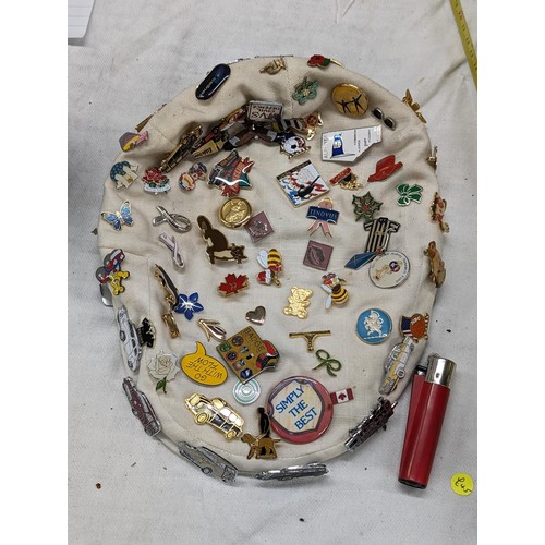 71 - Flat cap with large amount of assorted pin badges attached