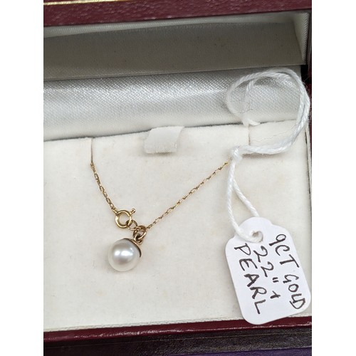 481 - 9 carat gold mounted single pearl pendant on similar 22