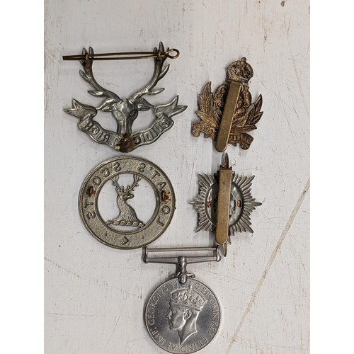 21 - 1939-1945 WWII medal and 4 x military cap badges