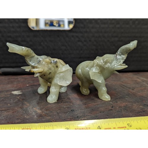 86 - Pair of green jade elephants - 1 with end of tail missing and the other with part of ear and end of ... 