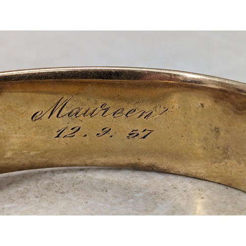 435 - 9 ct metal core bangle with half engraved foliage patterning and safety chain - engraved on inner Ma... 