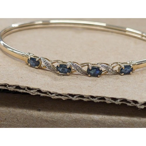 473 - 375 hallmarked 9 carat gold bangle with sapphire and diamonds - 4.1 gm - all proceeds from this lot ... 