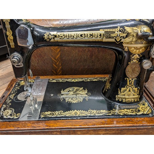 255 - Antique Singer 127k hand crank sewing machine in bentwood case, moves freely