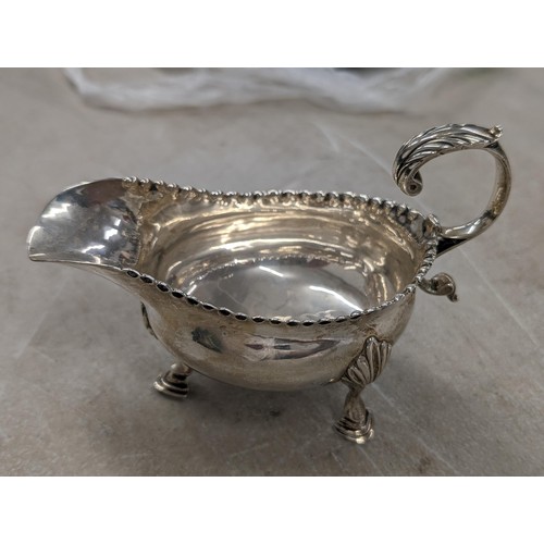 184 - Sheffield hallmarked silver 3 footed sauce/gravy boat in very good condition - 105.8 gm