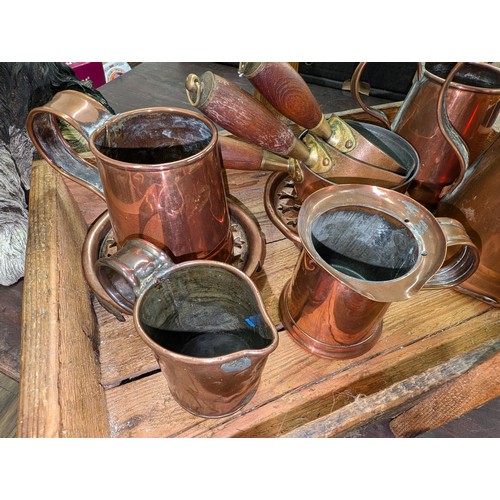 19 - Old wooden tray with handle containing quantity of old copper tankards, jugs and small pan set