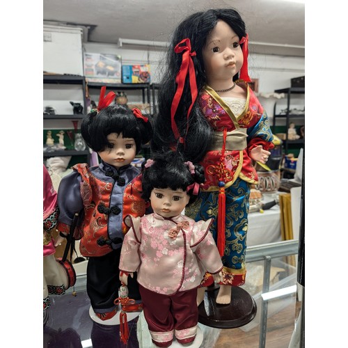 309 - Collection of 7 x Chinese porcelain dolls in traditional dress, 6 standing with stands and 1 x kneel... 