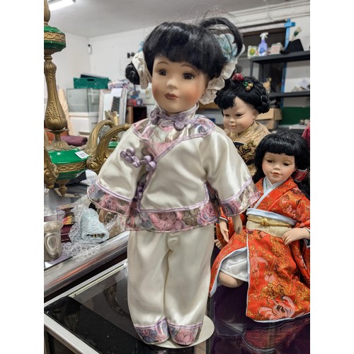 309 - Collection of 7 x Chinese porcelain dolls in traditional dress, 6 standing with stands and 1 x kneel... 