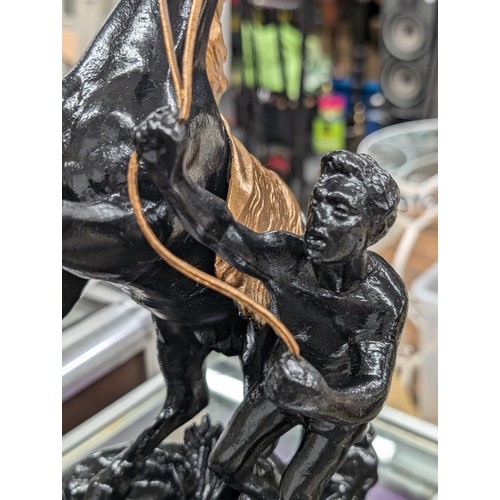 210 - Large painted spelter young man restraining rearing horse figure with gold detailing - horses right ... 