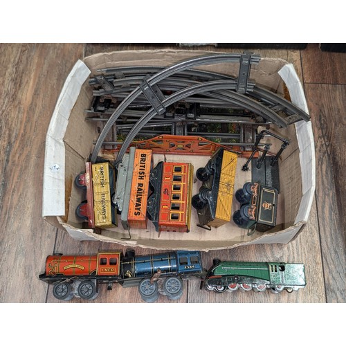 18 - Triang 0 gauge wind up train set including 3 x engines, carriage, rolling stock and track etc